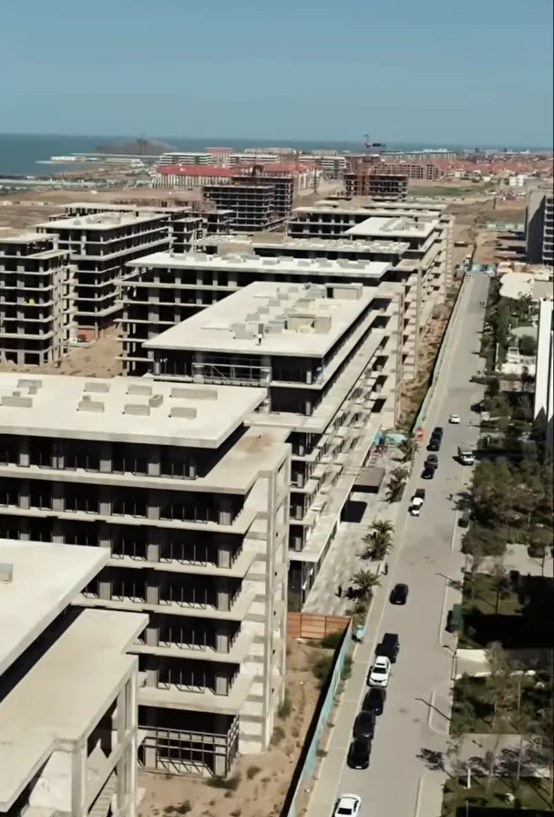 Lighthouse 2 in September 2026: a street between the buildings, facade finishing still under way