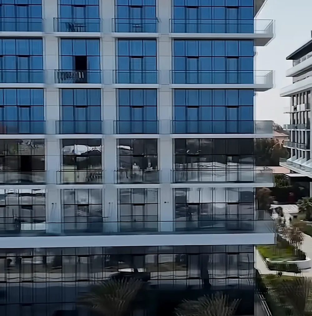 The facade of a Lighthouse building: floor-to-ceiling glass and white frames