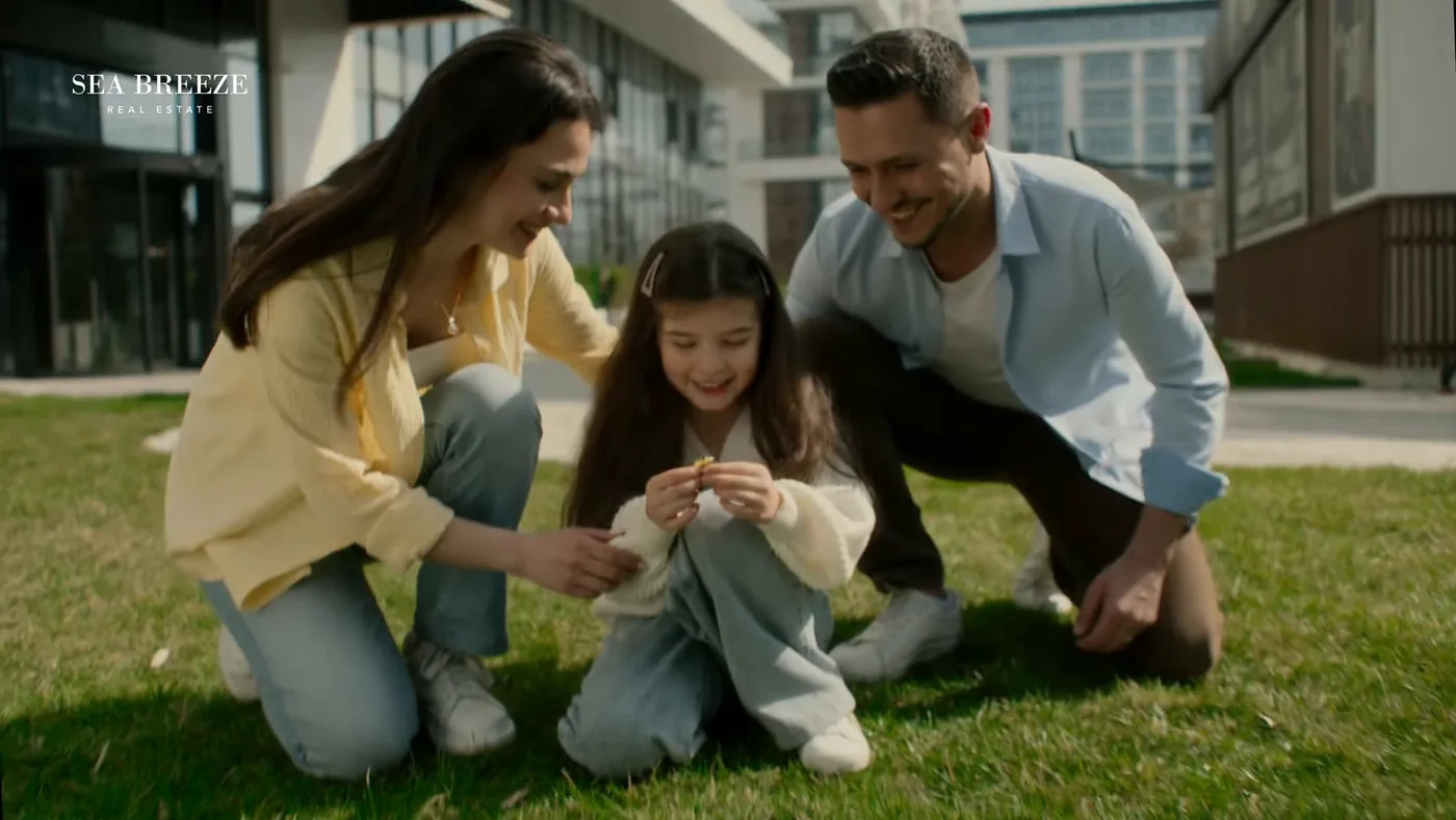 The lawn in front of a Lighthouse building: a family playing on the grass