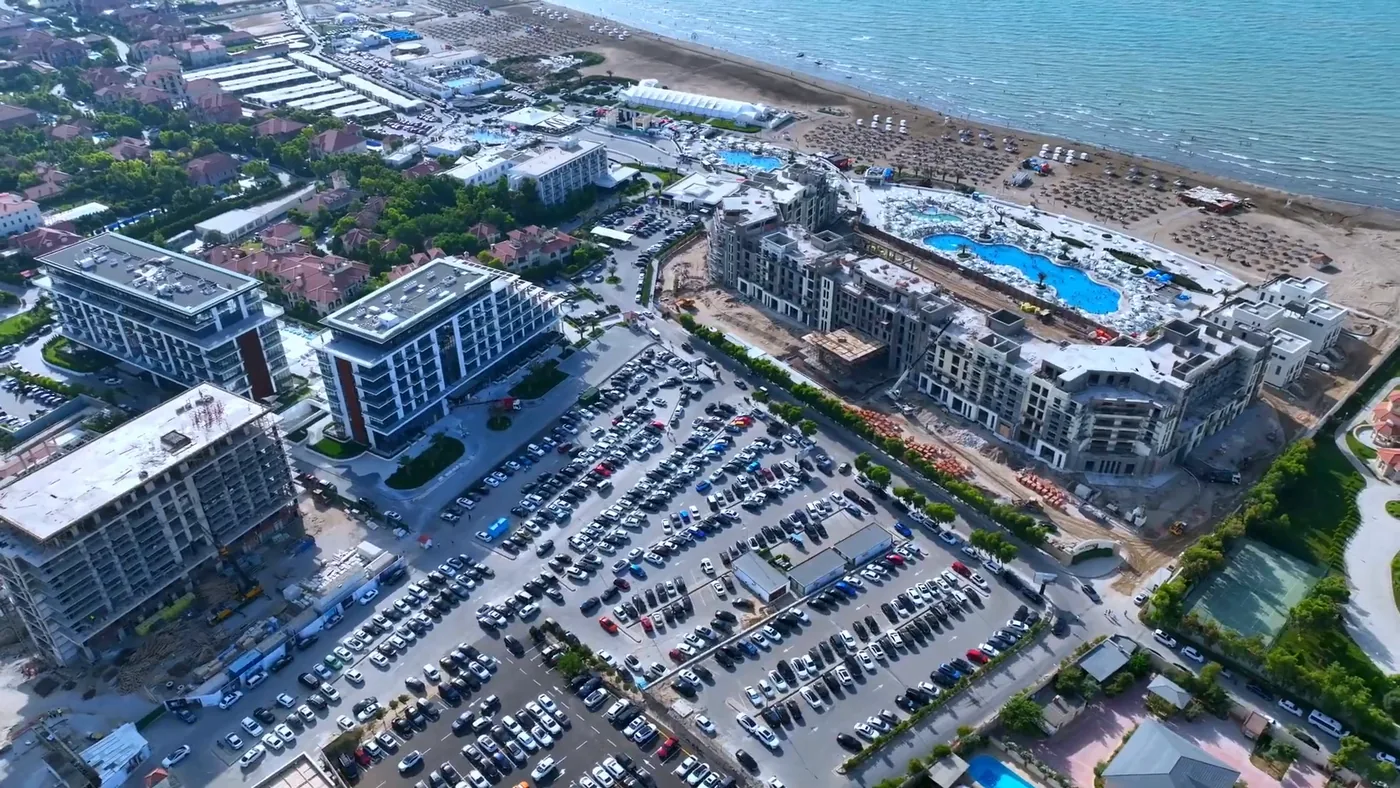 The Lighthouse neighborhood and the resort's shore from above: buildings on the left, beach pools by the sea